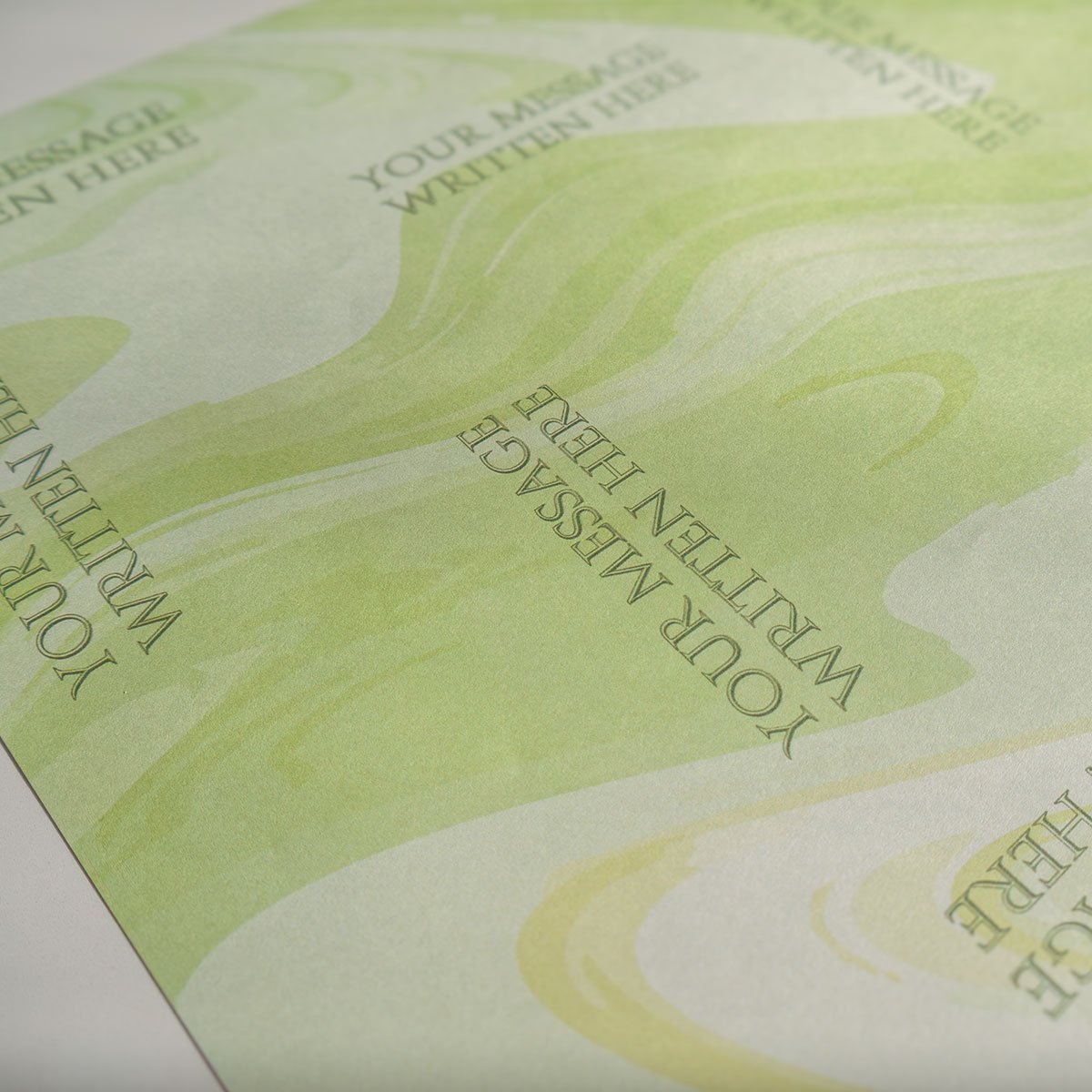 Light green and white liquid marble or swirl texture with repeated placeholder text reading "YOUR MESSAGE WRITTEN HERE" positioned at various angles