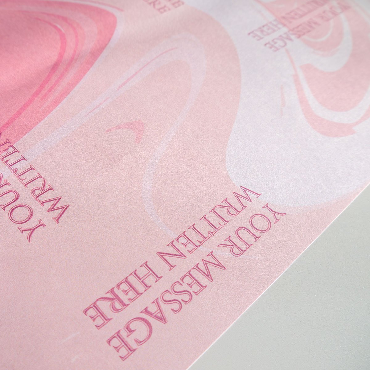 Pink and white liquid marble or swirl texture with repeated placeholder text reading "YOUR MESSAGE WRITTEN HERE" positioned at various angles