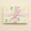 Pale yellow background with pastel butterflies in pink, blue, and yellow, scattered numbers, and personalised names (Sofia, Ellie) throughout